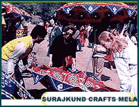 craftsman showing his products at Suraj Kund Mela